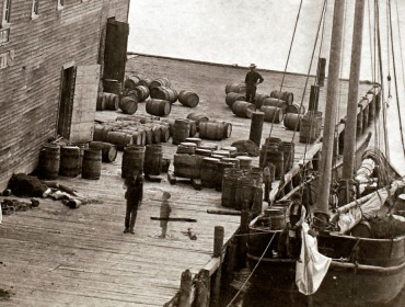 The W. H. Witherle & Co. dock and salt storage building in Castine. Research suggests the casks are filled with salt. PHOTO: COURTESY NEW ENGLAND HISTORIC GENEALOGICAL SOCIETY