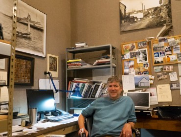 Kevin Johnson, photo archivist at Searsport’s Penobscot Marine Museum, at his work station where he and others digitize old photographs. PHOTO: TOM GROENING