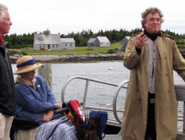 Jamie Wyeth, right, speaks on Allen Island as David Greene, Colby College president and Phyllis Wyeth listen.