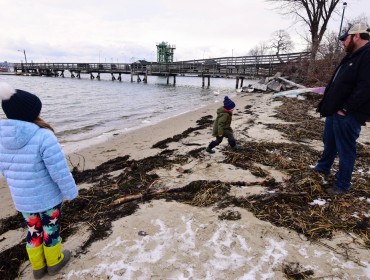 Tom Werner and his children on the Peaks Island shore.