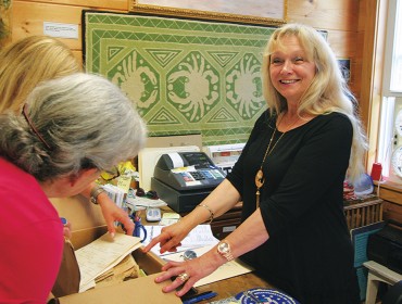 Karin Whitney, right, works at the Preble-Marr Historical Museum, part of Cranberry House, a community hub.