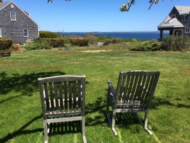 Two empty rockers on Bailey Island lawn.