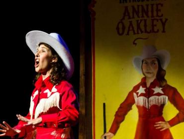 Courtney Naliboff as Annie Oakley.