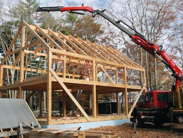 A crane is used to lift timbers into place.