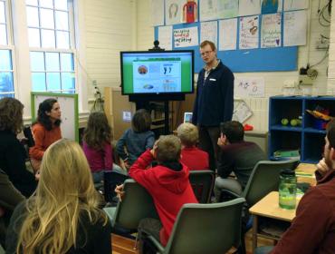 Ben Algeo explains the eMonitor to Monhegan students during Energy Day in January