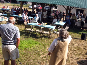 Jim Van Fleet, left, and Leila Bisharat address Chebeague islanders at a picnic on Aug. 6.