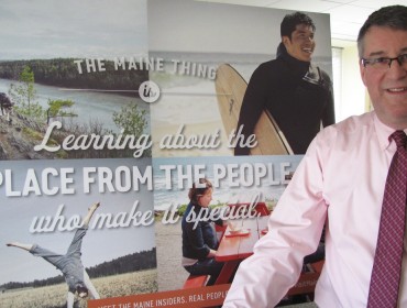 Steve Lyons poses with a recent marketing billboard