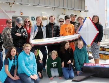 Swan's Island students on the deck of the State of Maine with their boat, Black Rock.