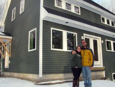 Keaton and Megan Scarponi in front of their new house.