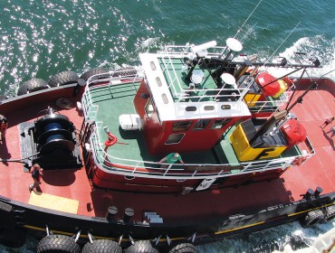 One of Fournier's tugs works alongside Maine Maritime Academy's State of Maine last summer.