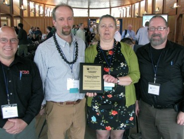 Marian Chioffi and Chris Smith of the Monhegan Plantation Power District (center) were joined by representatives of Innovative Construction & Design Solutions, LLC after receiving the Island Energy Innovation Award at the 2017 Island Energy Conference