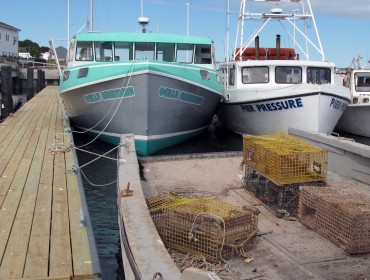 Lobster boats docked inside Eastport’s breakwater. Lobster boats throughout Maine now face a trade hurdle their Canadian counterparts do not.