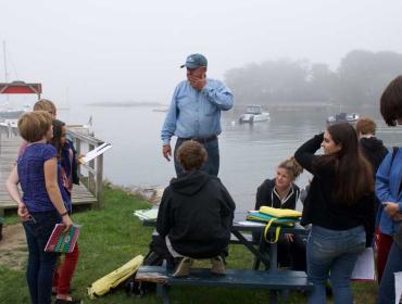 Students from Harpswell Coastal Academy work in the field.