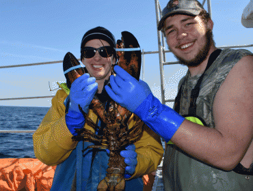  Teacher Kathryn Meyer and student Zack Harvey hold a big lobster.