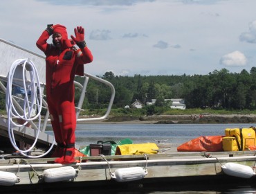 Demonstrating an immersion suit.