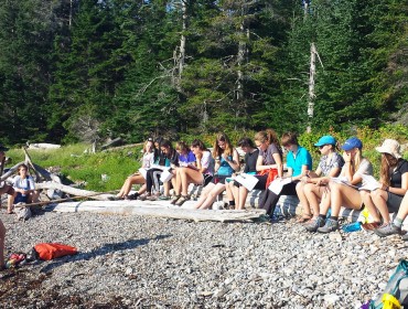 Students on the shore during a lesson.