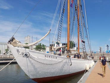 The Schooner Bowdoin's master, Will McLean, walks beside the vessel in Quebec City.