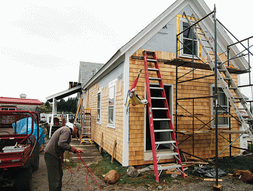 Volunteers pitch in to work on the store building.