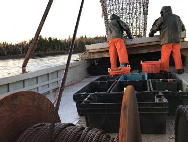 The crew working with the drag at the stern.