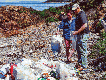 Volunteers pick up trash.