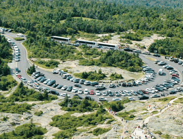 Top of Cadillac crowded with cars