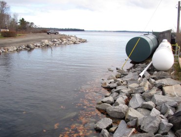 Fuel tanks sit close to the water during a high-tide event in Lincolnville Beach.