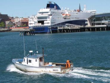 Lobster boat crosses behind Nova Star