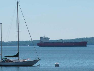 Sailboat, cargo ship off Searsport