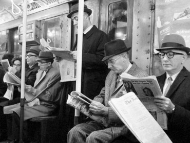 reading newspapers on the subway