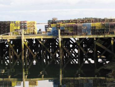 Lobster traps piled on a dock in Corea.