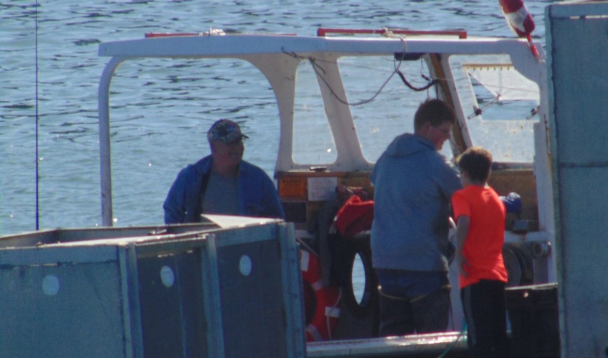 Ryan Murphy hands out cards explaining how to turn on the Libby Island fog horn.