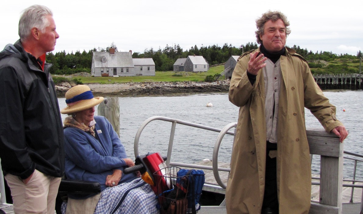 Jamie Wyeth, right, speaks on Allen Island as David Greene, Colby College president and Phyllis Wyeth listen.