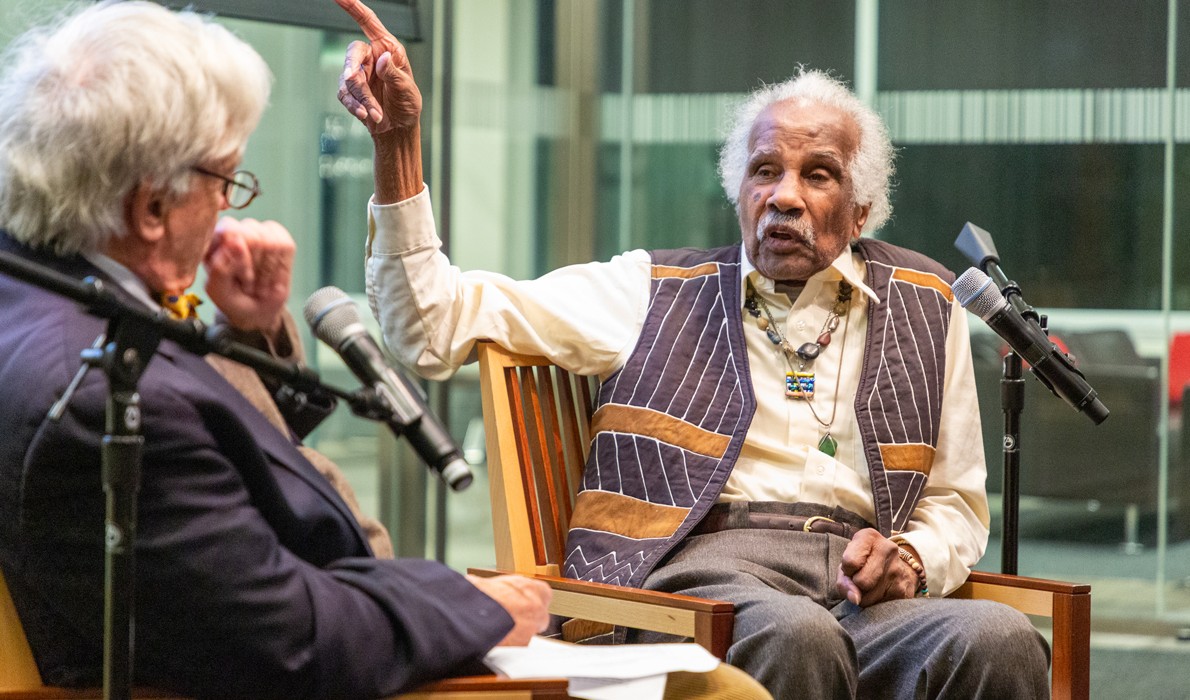 Ashley Bryan, right, gestures while speaking about his work at an event at the University of Pennsylavnia.