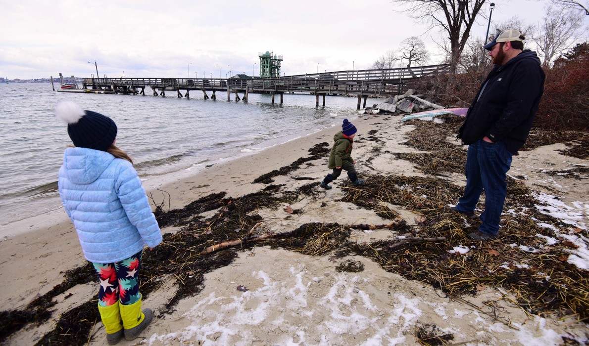 Tom Werner and his children on the Peaks Island shore.