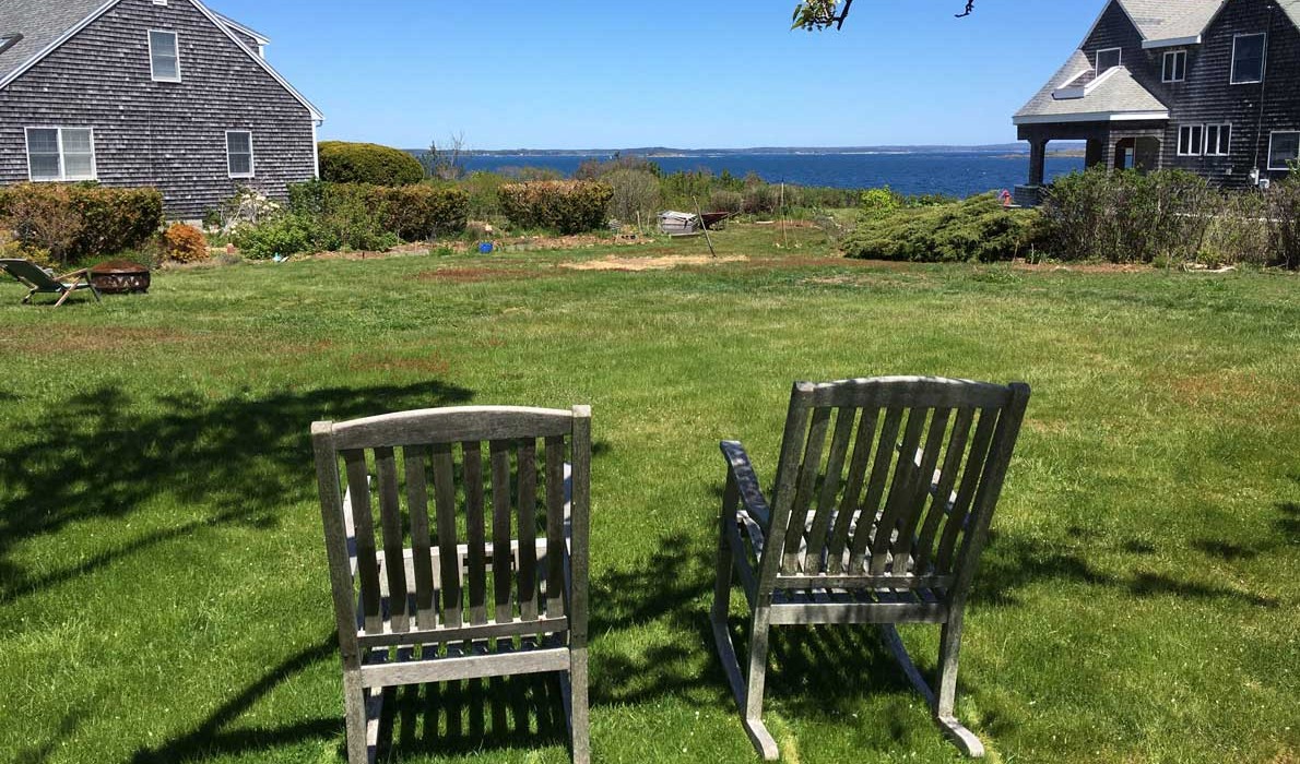 Two empty rockers on Bailey Island lawn.