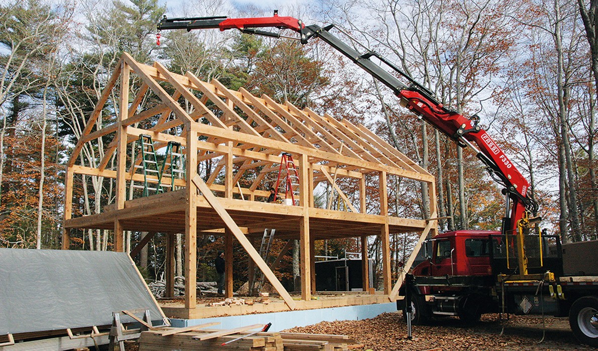 A crane is used to lift timbers into place.