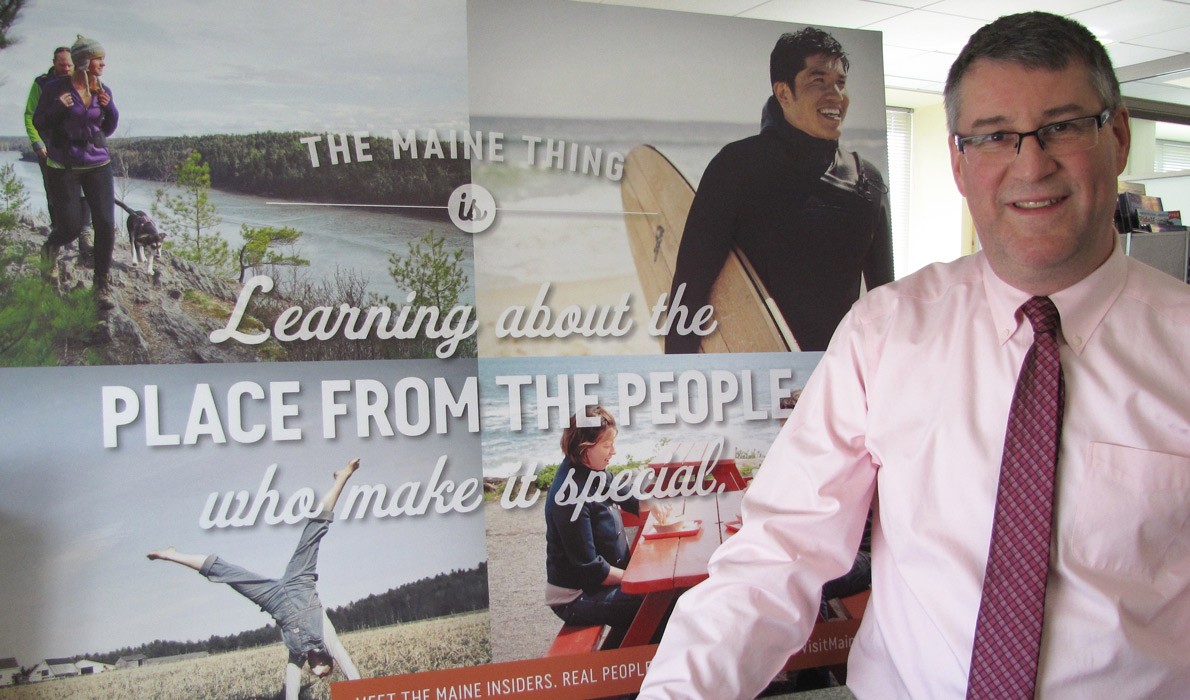 Steve Lyons poses with a recent marketing billboard