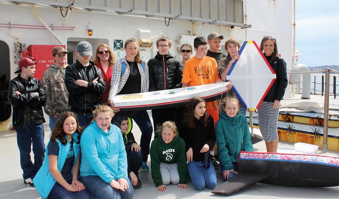 Swan's Island students on the deck of the State of Maine with their boat, Black Rock.