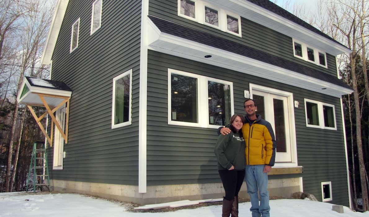 Keaton and Megan Scarponi in front of their new house.