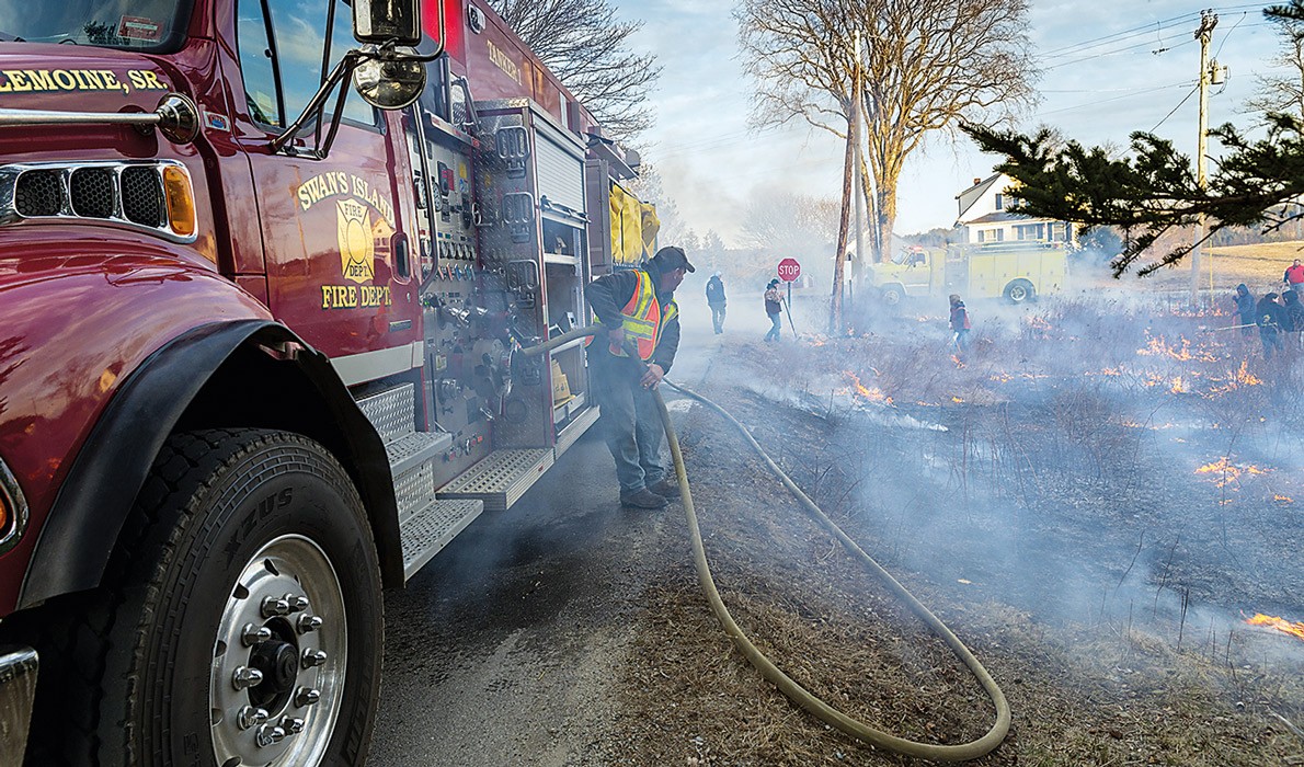 Volunteers burn fields on Swan's Island