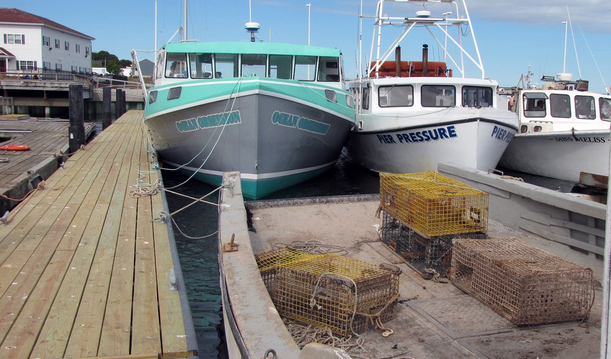 Lobster boats docked inside Eastport’s breakwater. Lobster boats throughout Maine now face a trade hurdle their Canadian counterparts do not.