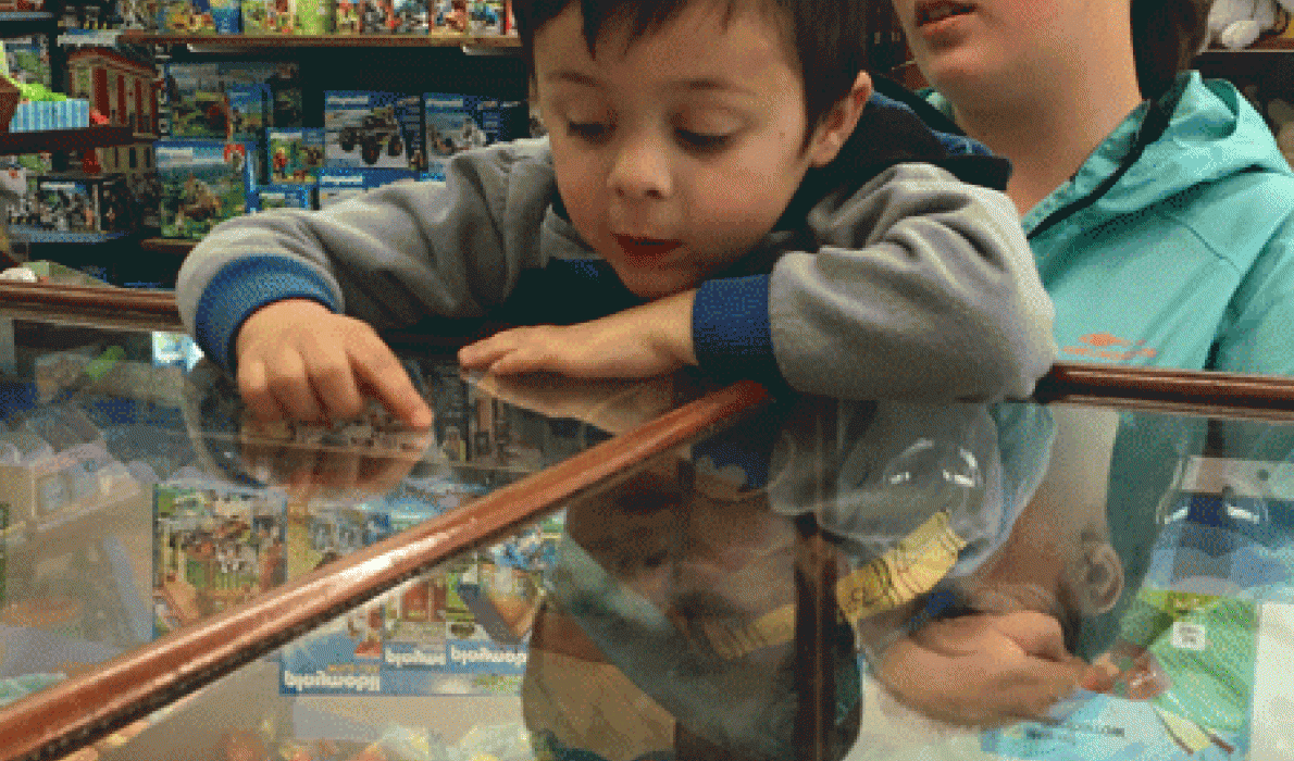 Corbin Davis peers through the glass counter to make his choice.