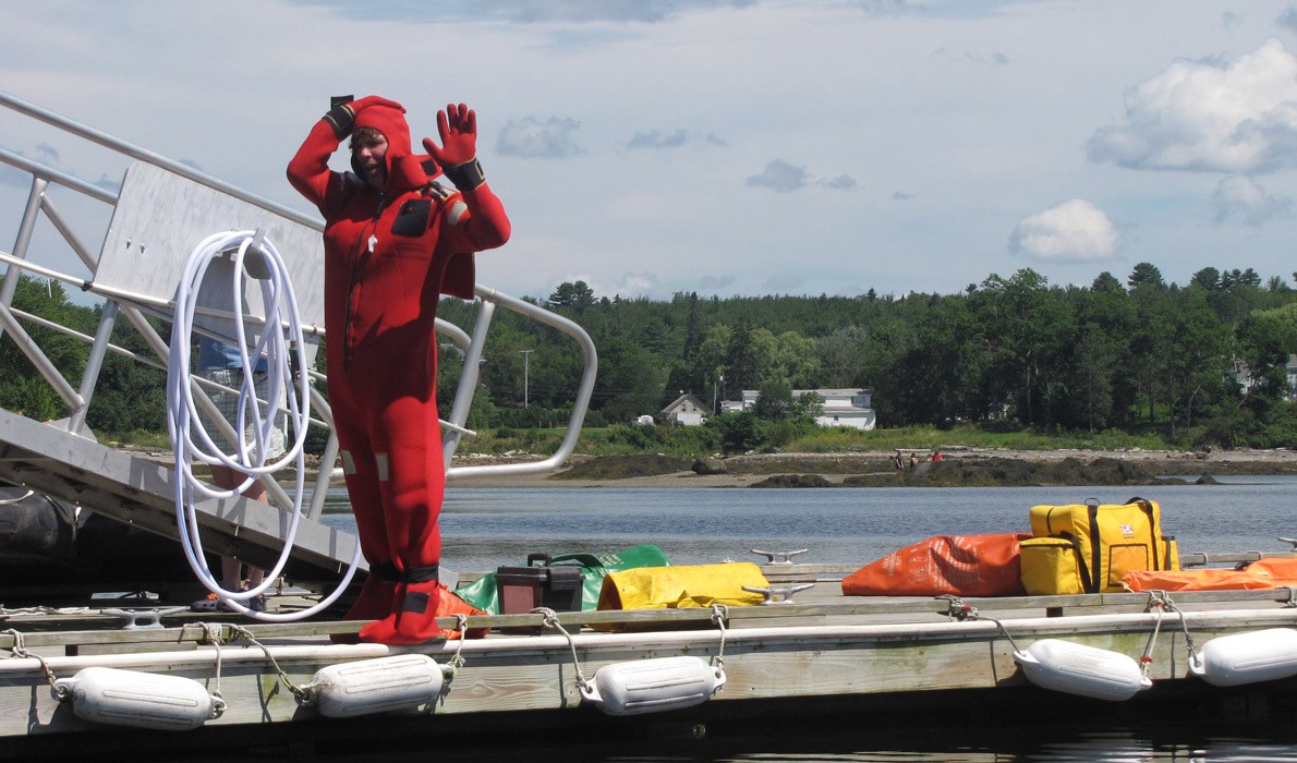 Demonstrating an immersion suit.