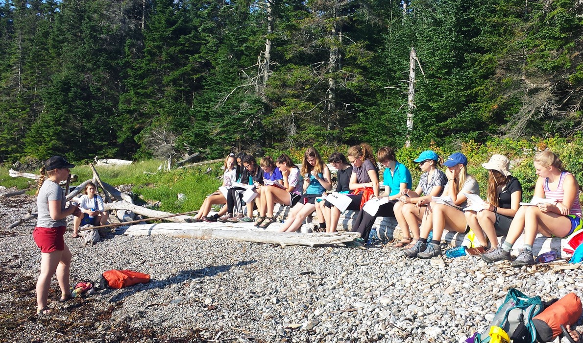 Students on the shore during a lesson.