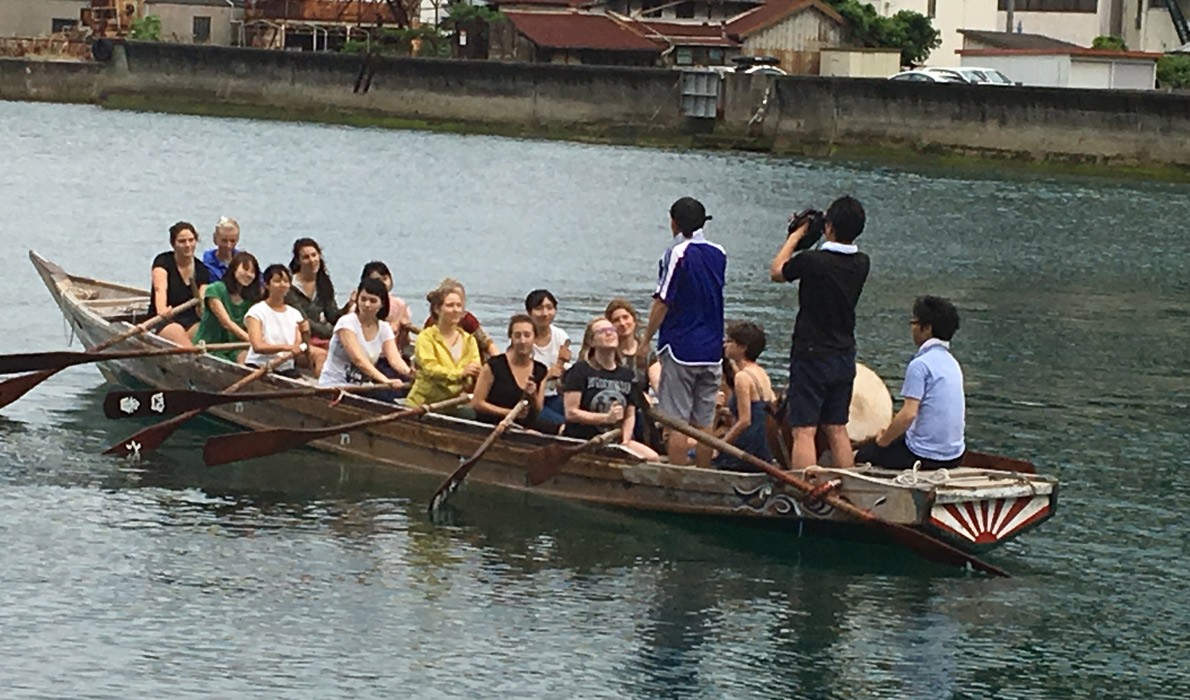 COA students try their hand at rowing a "dragon" boat.