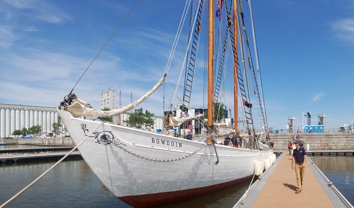 The Schooner Bowdoin's master, Will McLean, walks beside the vessel in Quebec City.