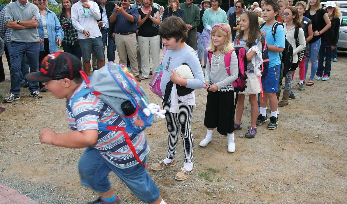 A student runs into Longfellow school.