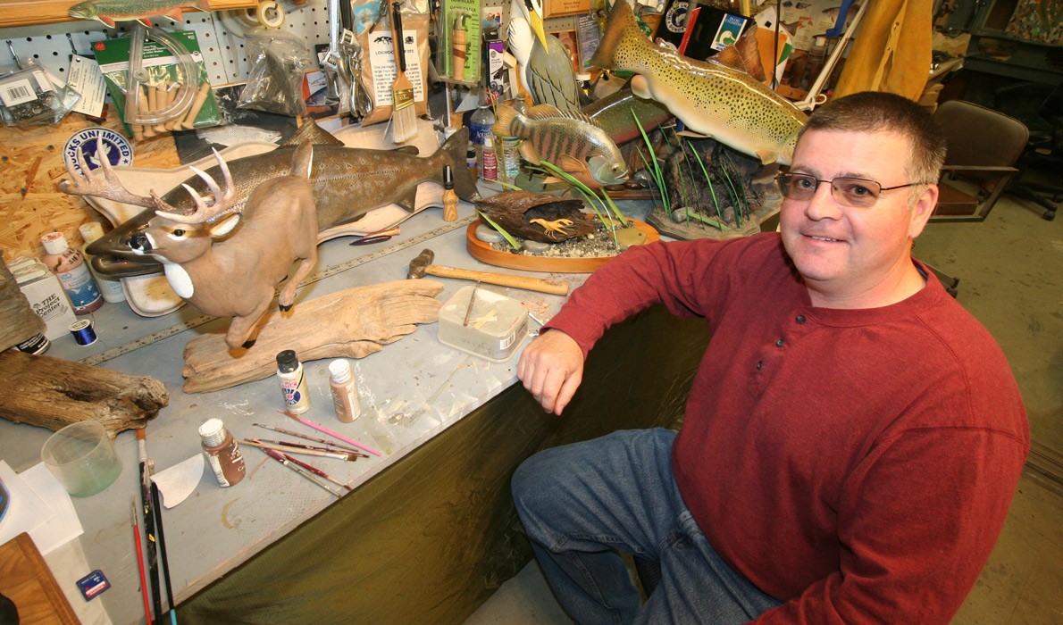 Joe McBrine with his carving work.