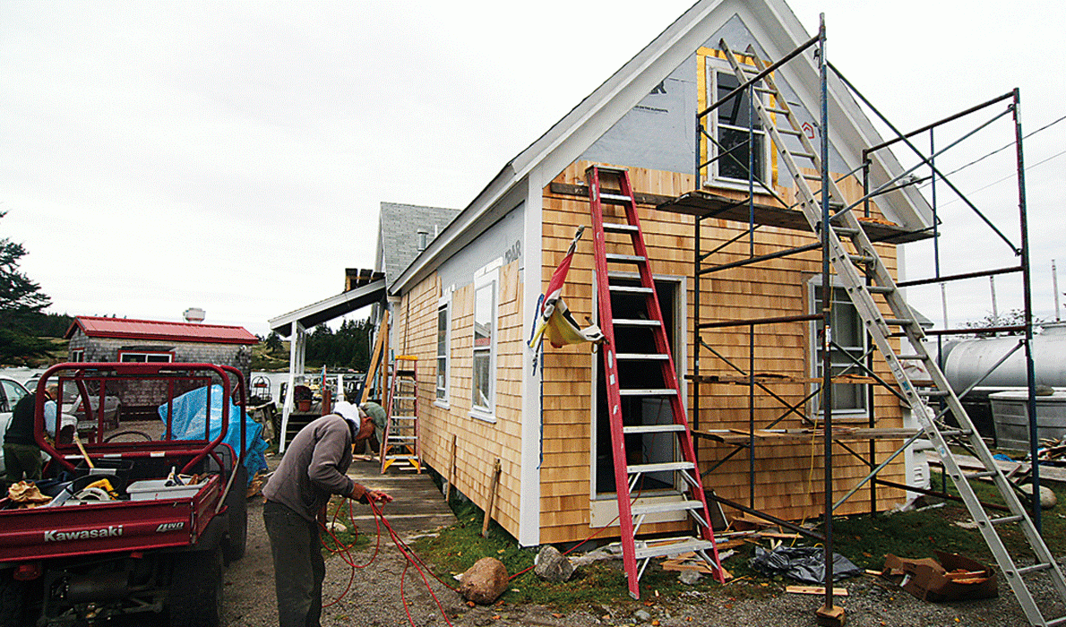 Volunteers pitch in to work on the store building.