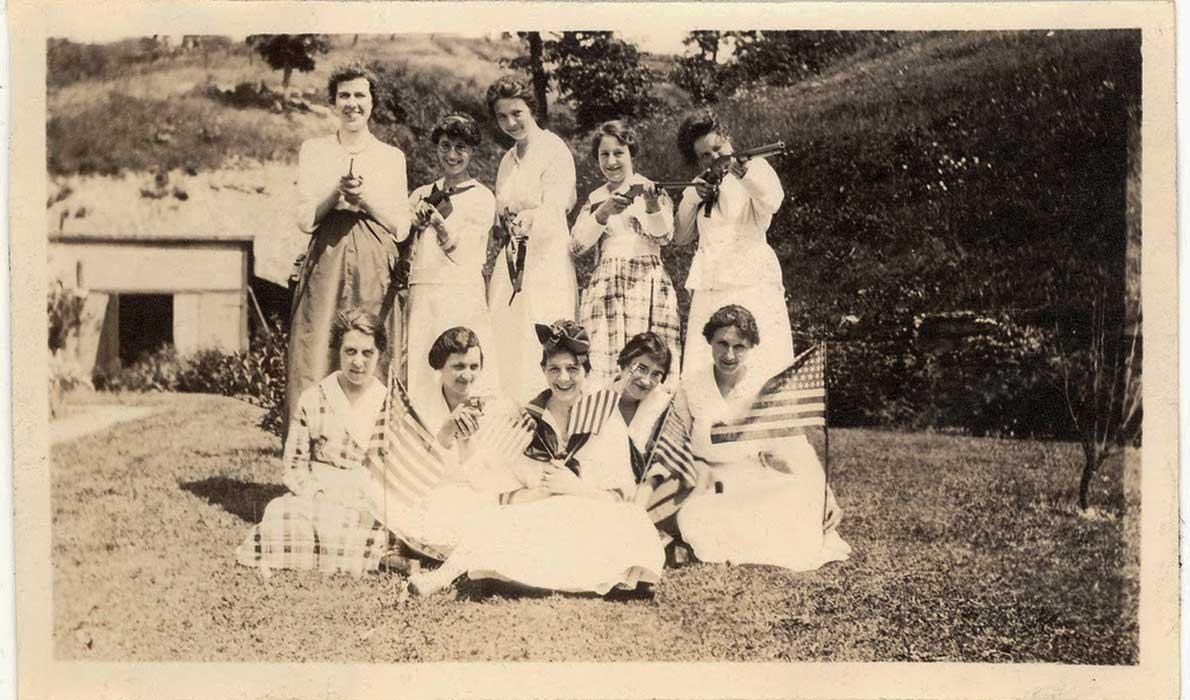 Women posing with guns